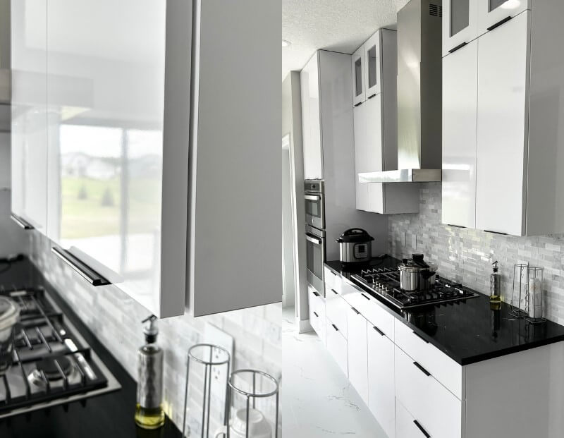 glossy white modern minimal slab custom cabinets by village home stores in a Quad Cities kitchen
