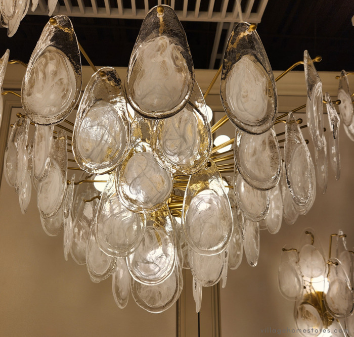 Darcia chandelier with textured stamped discs hanging.