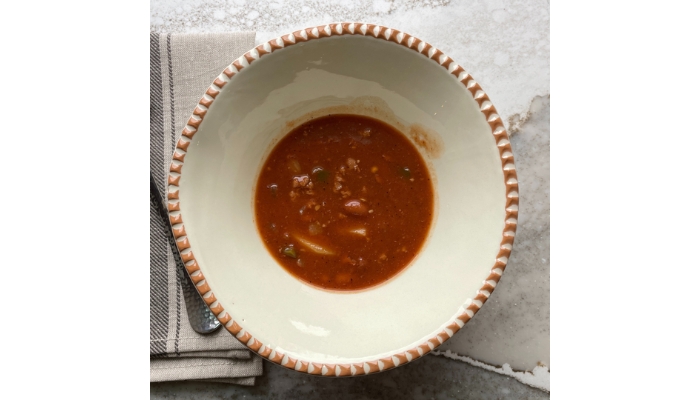 Overhead view image of potato chili in a bowl.