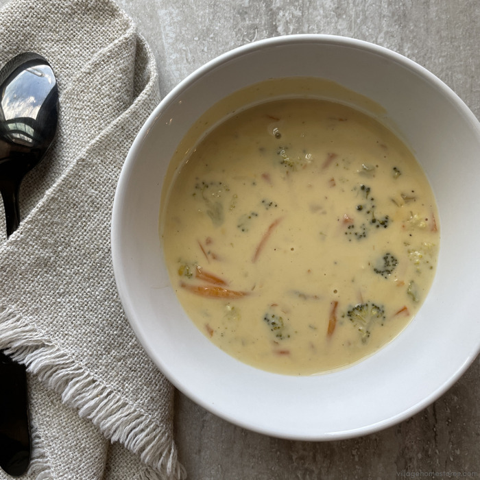 Overhead view image of creamy broccoli cheese soup