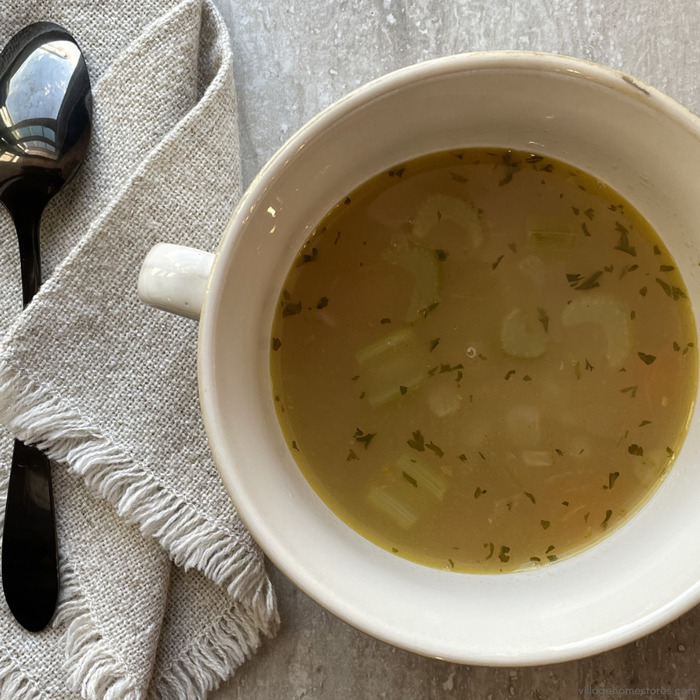 Overhead view image of chicken noodle soup in a bowl.