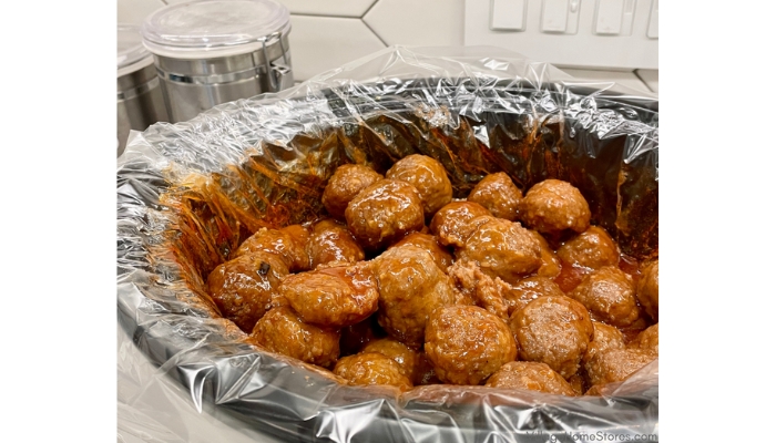 Crock pot with liner filled with bourbon meatballs