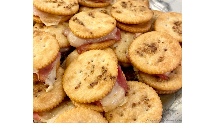 close up shot of glass pyrex dish with hawaiian ham and swiss slider crackers