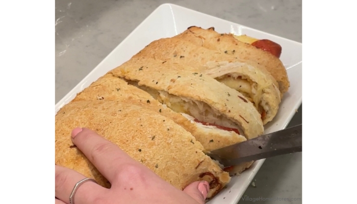 loaf of pizza bread being sliced