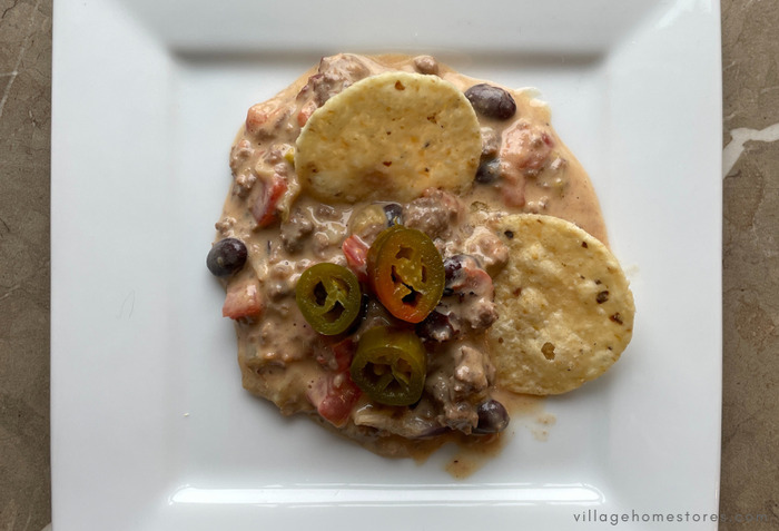 loaded venison queso on plate with jalapenos on top