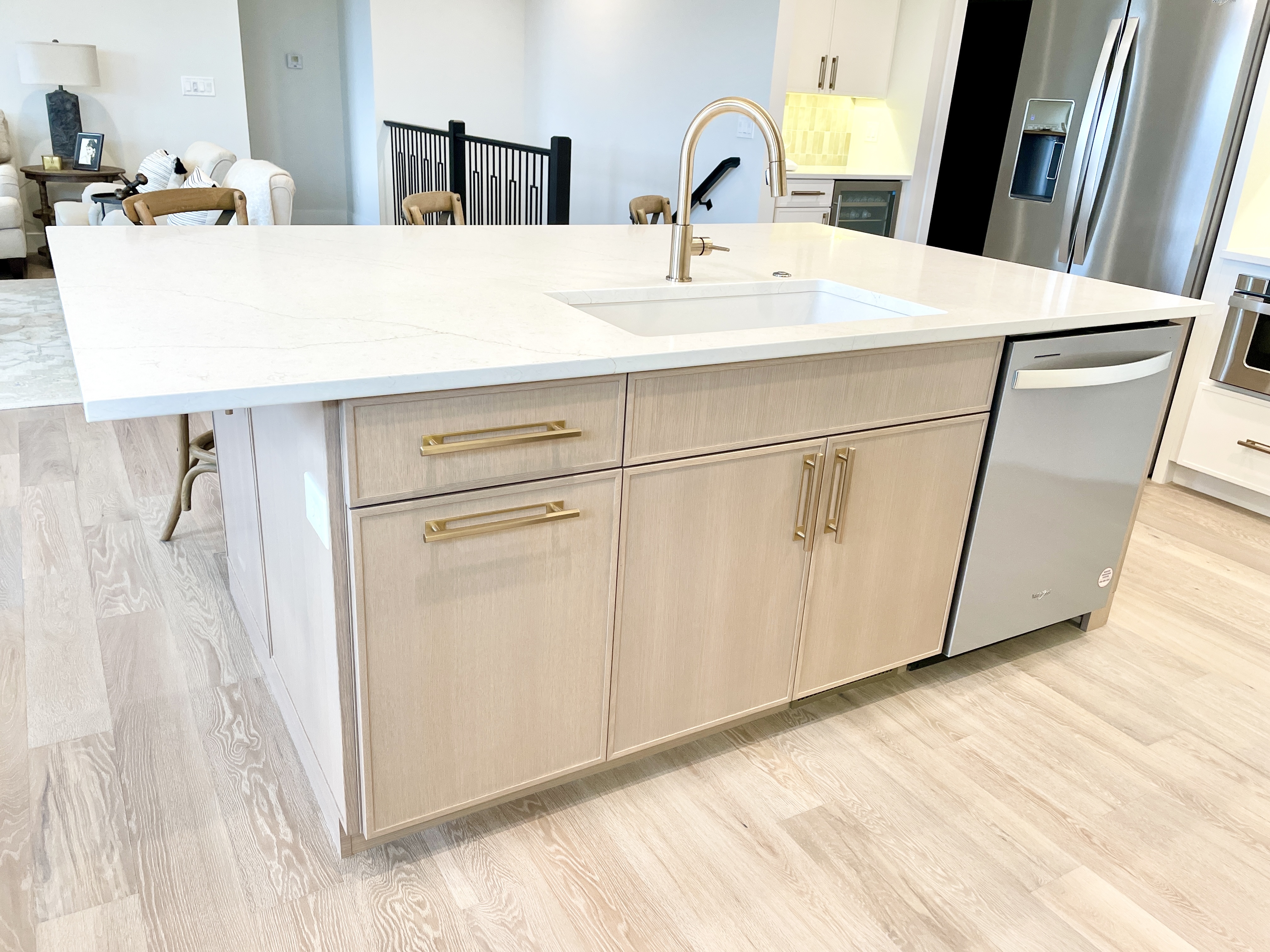 white oak with light stain kitchen island with sink and large single level countertop