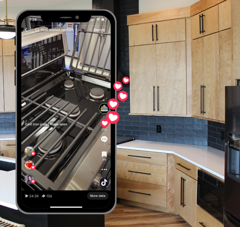  image of cast iron grates on cooktop in TikTok screenshot on iPhone over kitchen image with light cabinets and black appliances