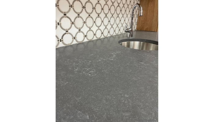 closeup image of quartz countertop surface of bar in gray hanstone storm quartz