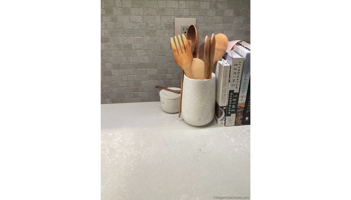 Hanstone Quartz in Coast color paired with mosaic wall tile and Scandinavian and Nordic cookbooks
