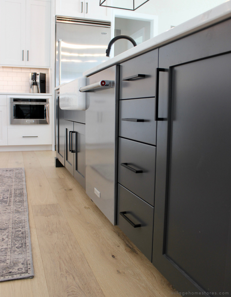 stainless steel dishwasher with kitchenaid handle installed in dark painted kitchen island