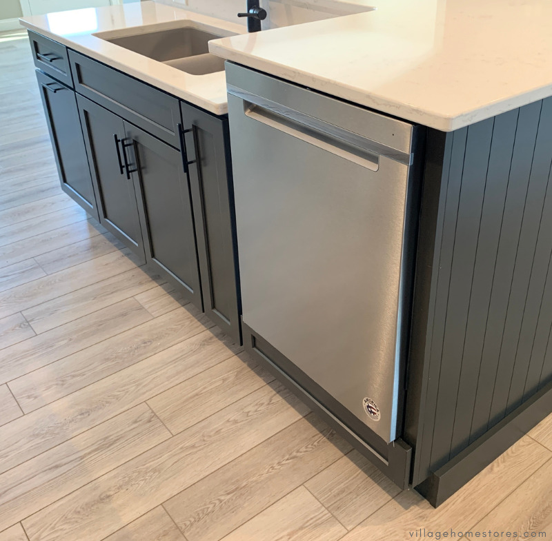 kitchen island with raised stainless steel dishwasher installed and pocket handle style