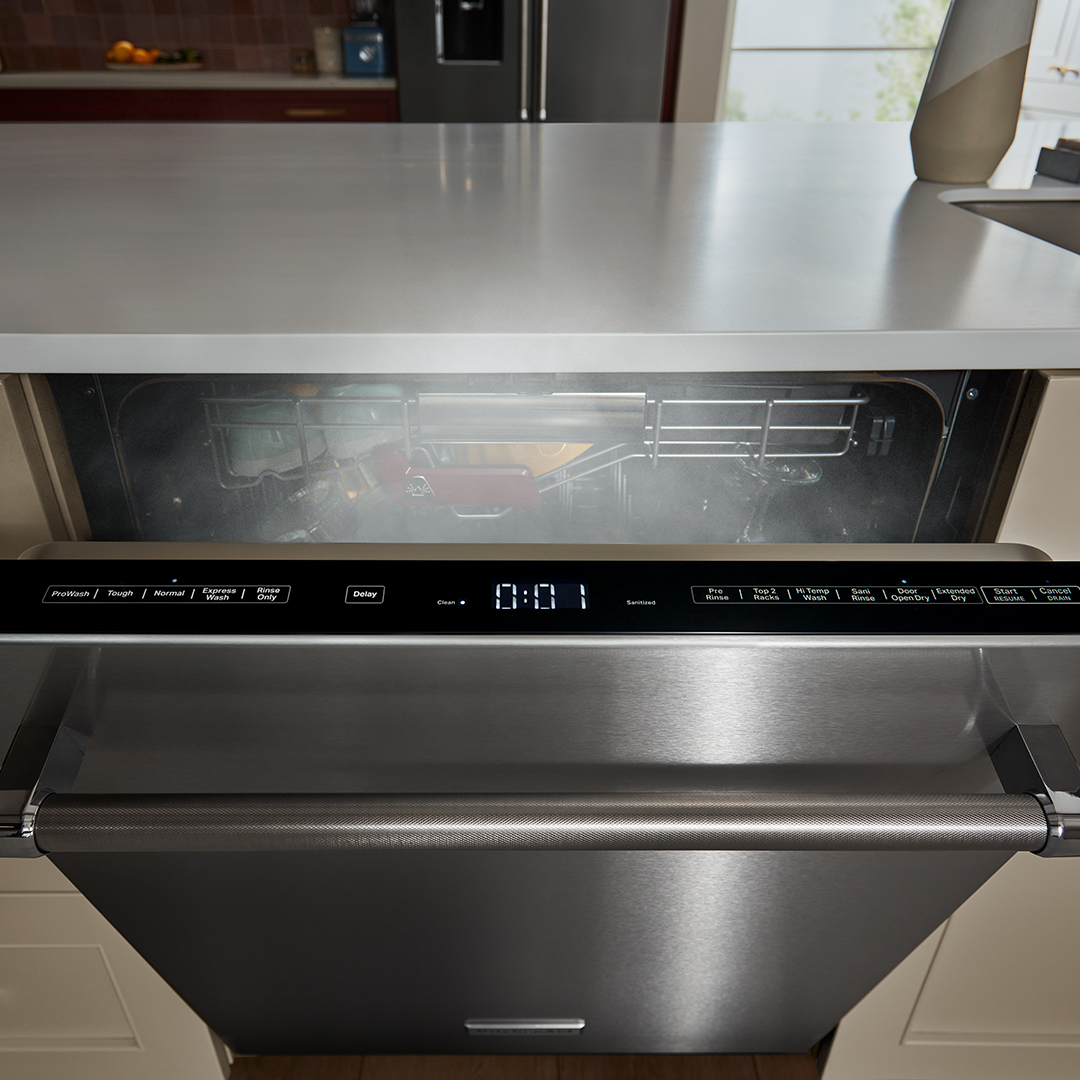 Image of dishwasher with controls on top of door and door popped open to release steam