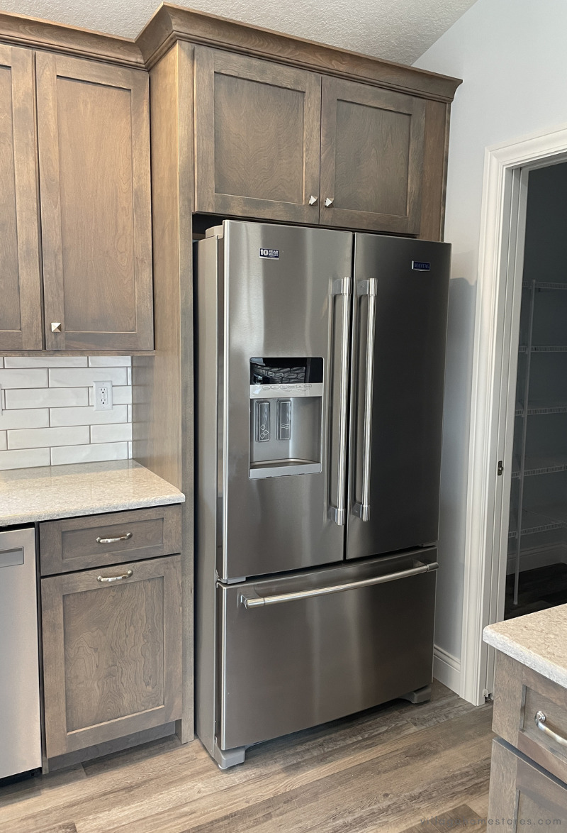 maytag double oven electric range with microwave hood both from village home stores installed in a gray cabinet kitchen