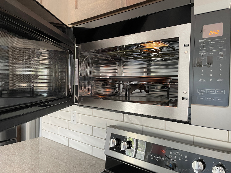 maytag microwave hood with door open showing crisping tray and rack