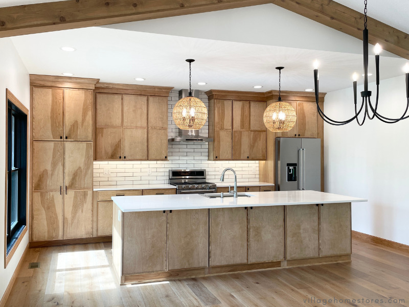 great room kitchen with large island, woven pendants and black chandelier