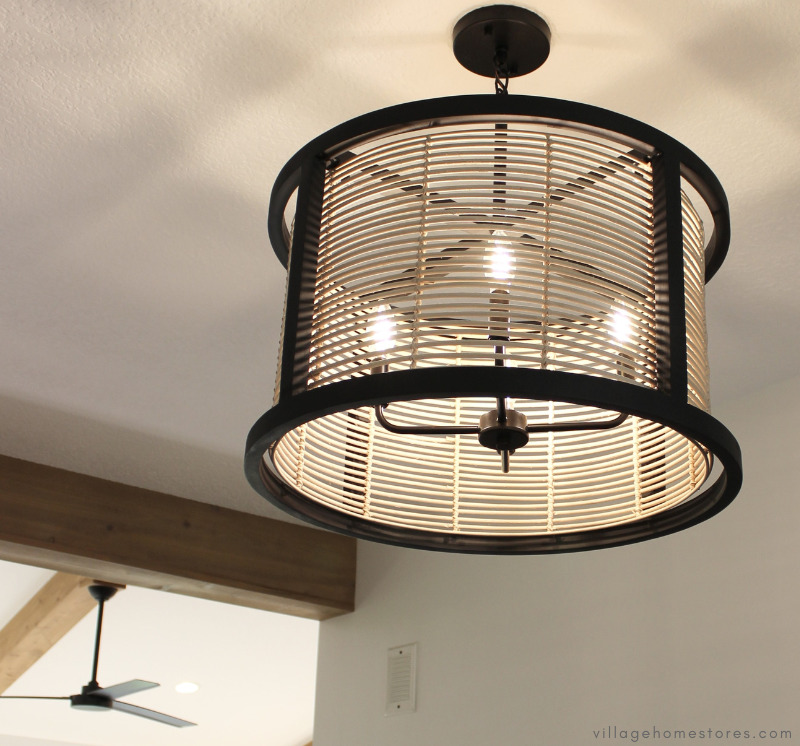 black and rattan woven ceiling light fixture in foyer of new home