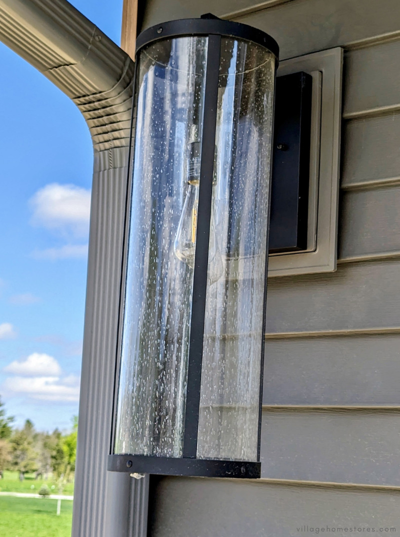 outdoor long tube shaped exterior light in black finish with rain seeded glass