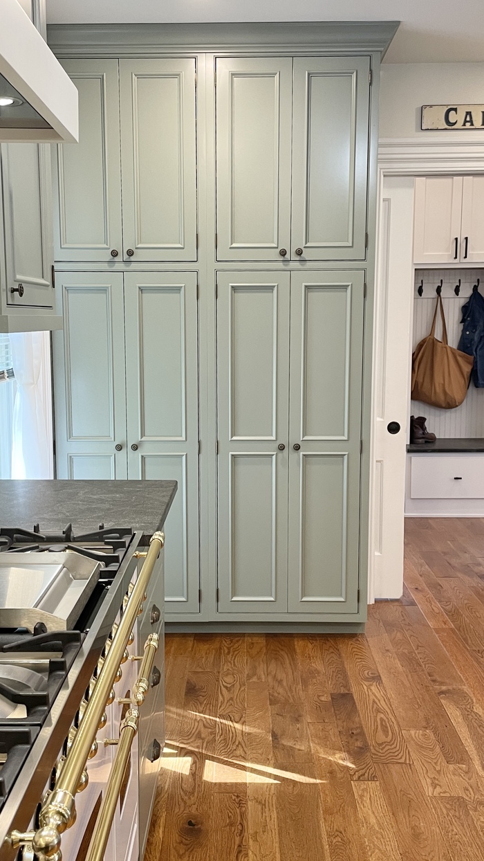 village home stores cabinets showing painted green  tall pantry units in kitchen
