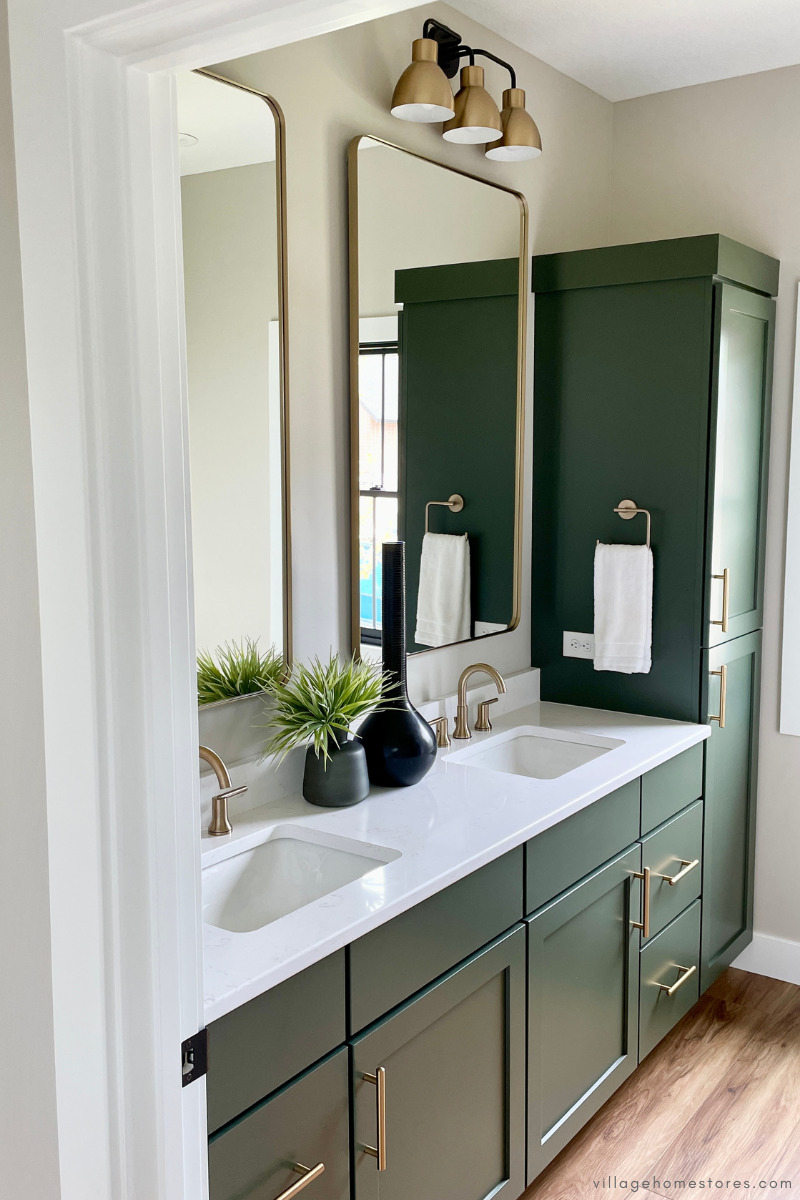 bathroom with green painted double sink vanity and tall linen cabinet 
