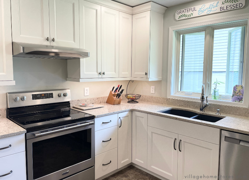 corner of kitchen remodel in moline with white cabinets and stainless appliances