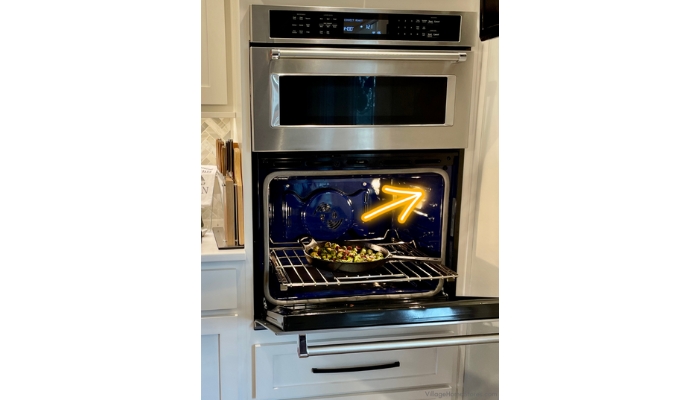 image of wall oven with door open and temperature probe plug in location. Arrow points to where to plug in kitchenaid probe