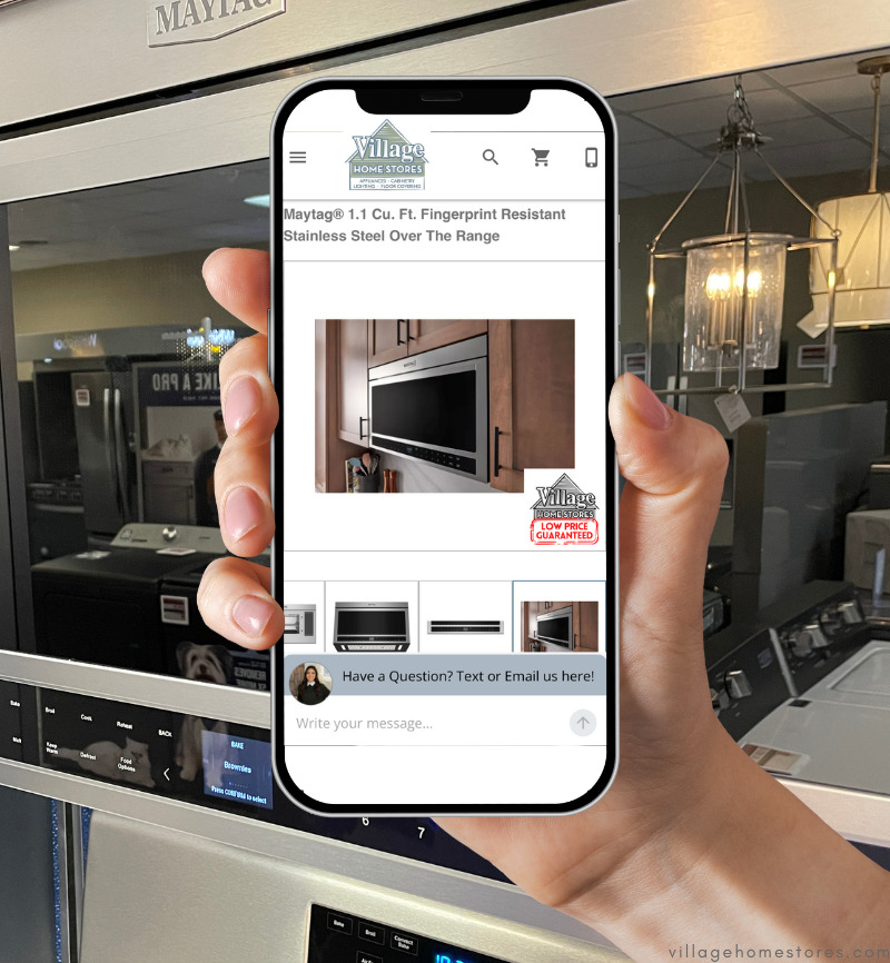 graphic of hand holding iphone with microwave pull up on village home stores website