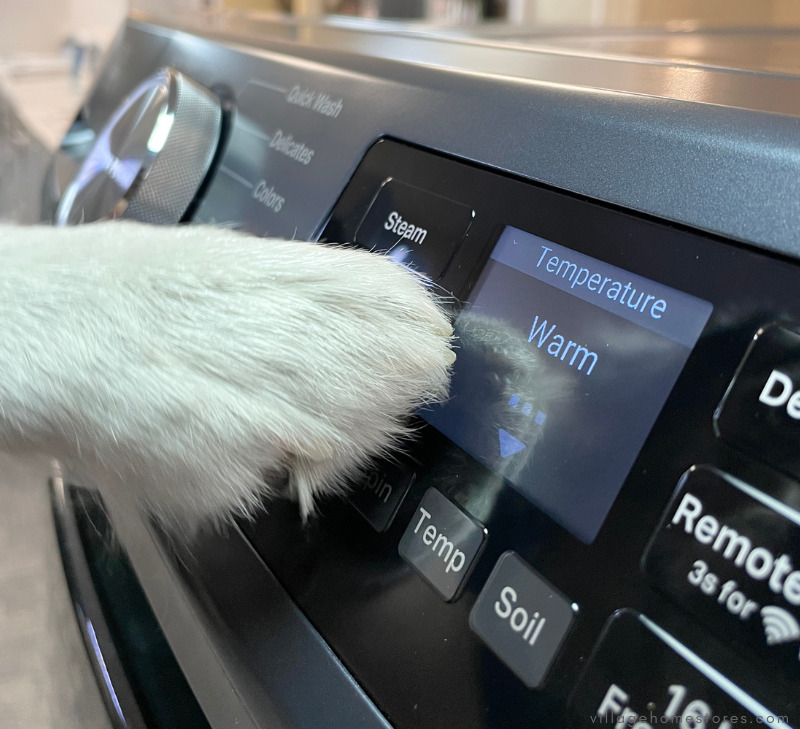 white dog paw selecting washer water temperature
