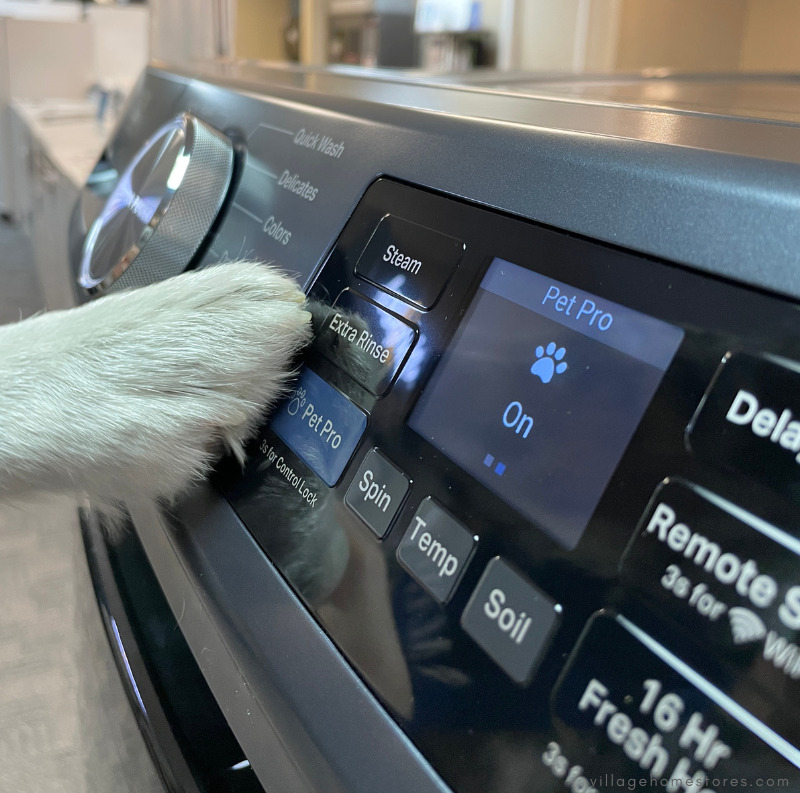 maytag washer controls with white pet paw pressing button