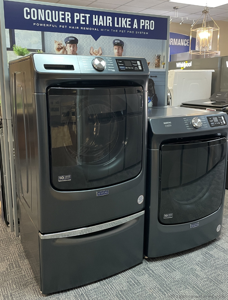 pair of front load maytag pet pro laundry in midnight steel finish shown with washer on pedestal