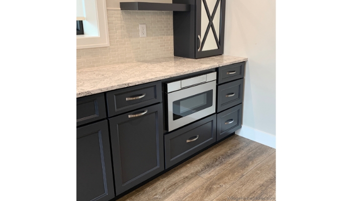 Microwave drawer installed in a blue cabinet design