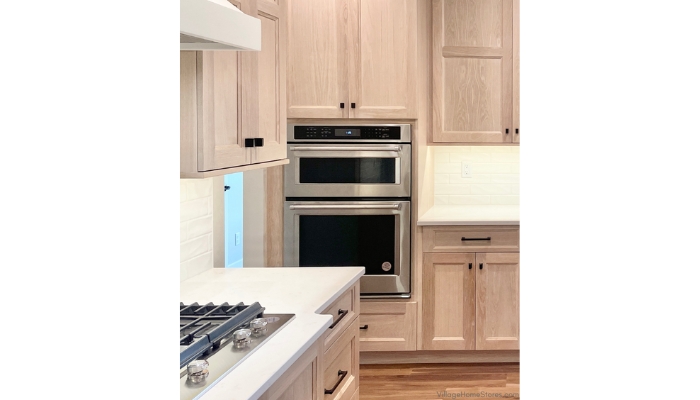 White oak cabinet kitchen with stainless steel combination microwave and wall oven unit installed