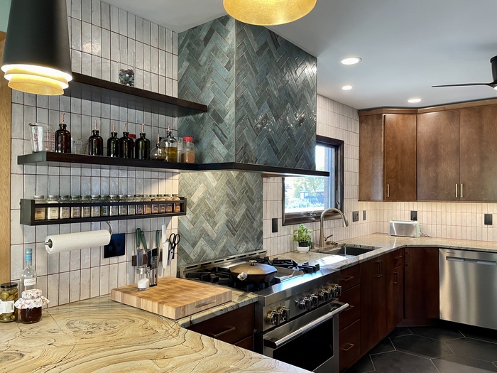 kitchen with green tiled range hood and wall backsplash in two patterns with open shelves