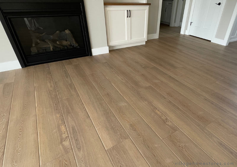 coretec flooring luxury vinyl plank in flaxen ash color installed in the open-concept great room