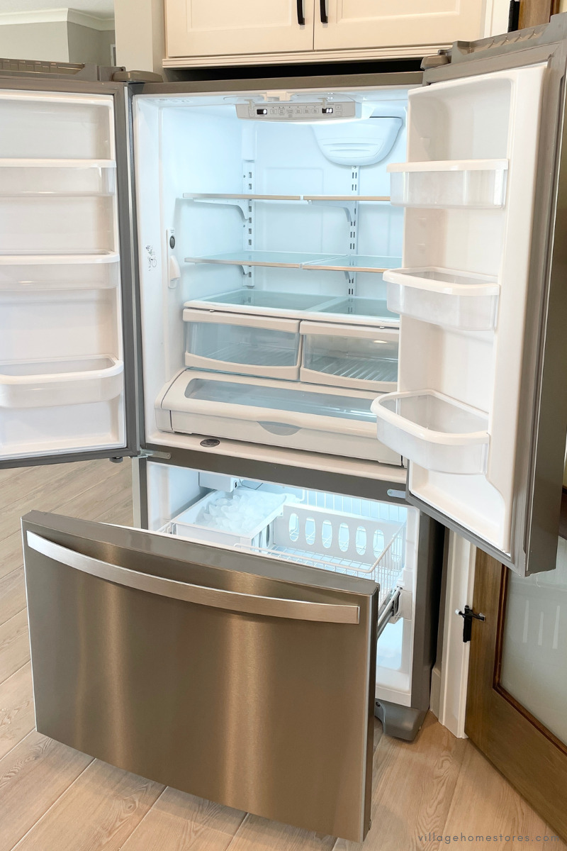 stainless steel whirlpool French door fridge with doors and freezer drawer open
