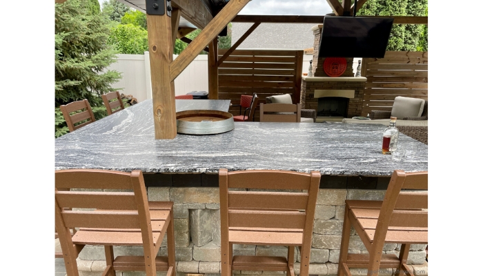outdoor black and white granite bar countertop with three barstools