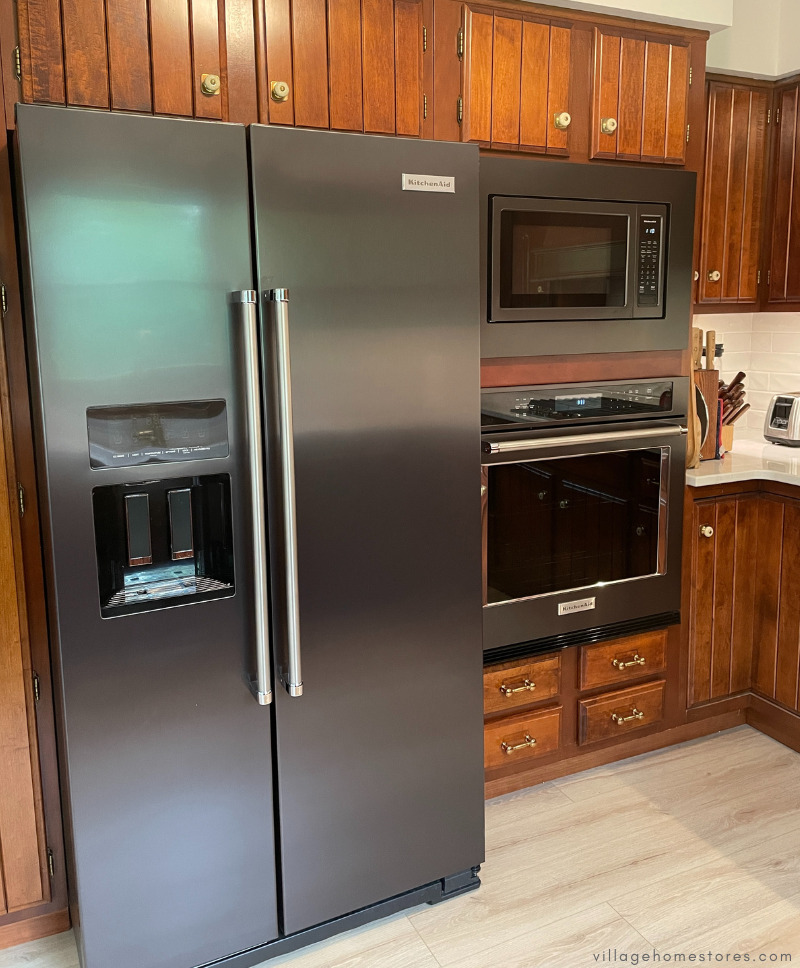 kitchenaid appliances in black stainless finish showing built in cooking and side by side refrigerator