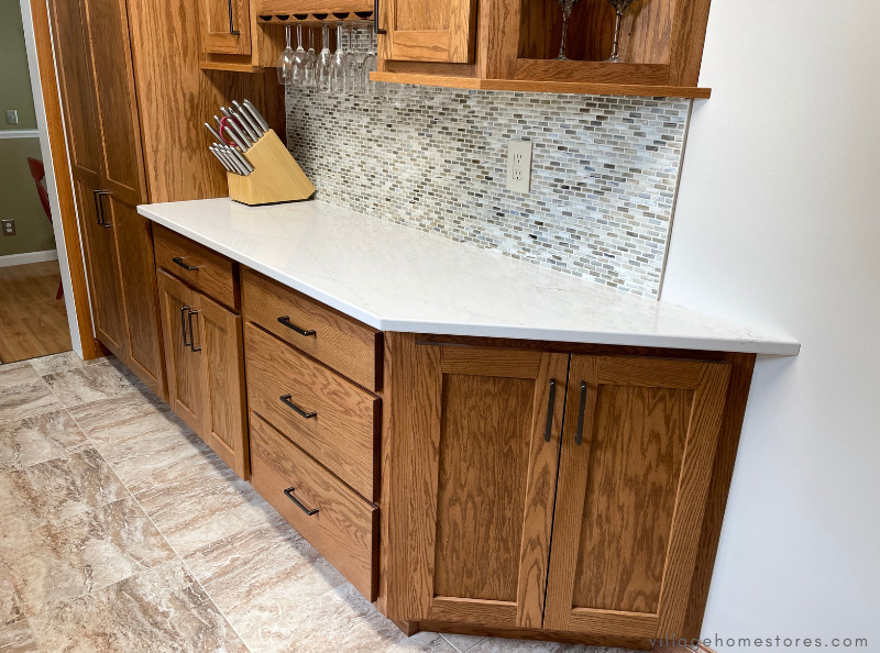 angled base end cabinet on the end of a cabinet run in an oak kitchen