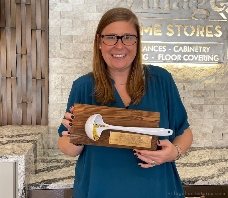 this year’s soup cookoff winner Rachele holding up the golden ladle plaque