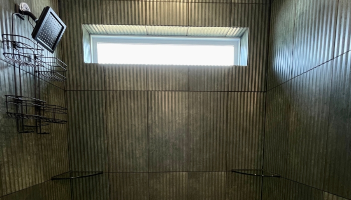 tiled shower installed in Bettendorf Iowa with fluted large format tiles