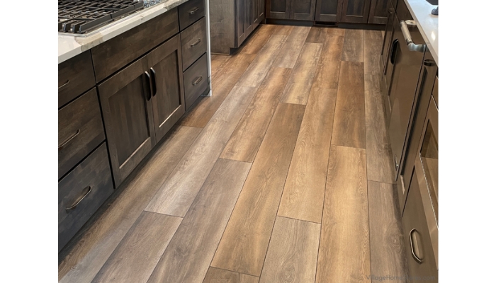 coretec vinyl flooring installed in grandure oak finish with warm gray stained kitchen cabinetry