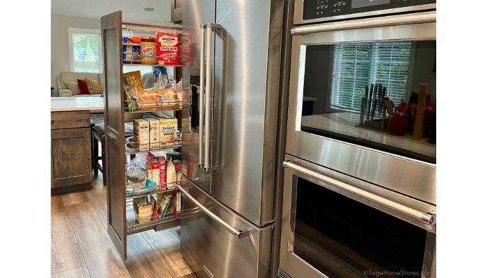 tall pullout pantry cabinet next to stainless French door counter depth refrigerator