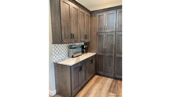 kitchen breakfast bar and coffee bar area with mosaic wall tile and gray stained cabinetry