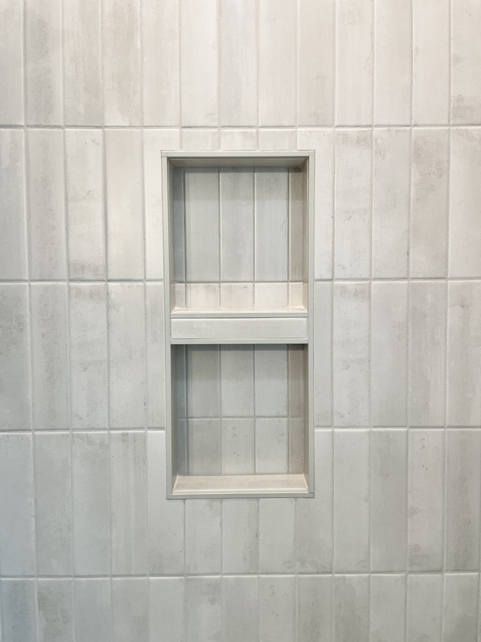 tiled shower niche in wall in a vertical soldier pattern