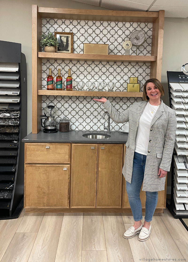 image of Beth Nordby in Village Home Stores showroom showing a staged wet bar display