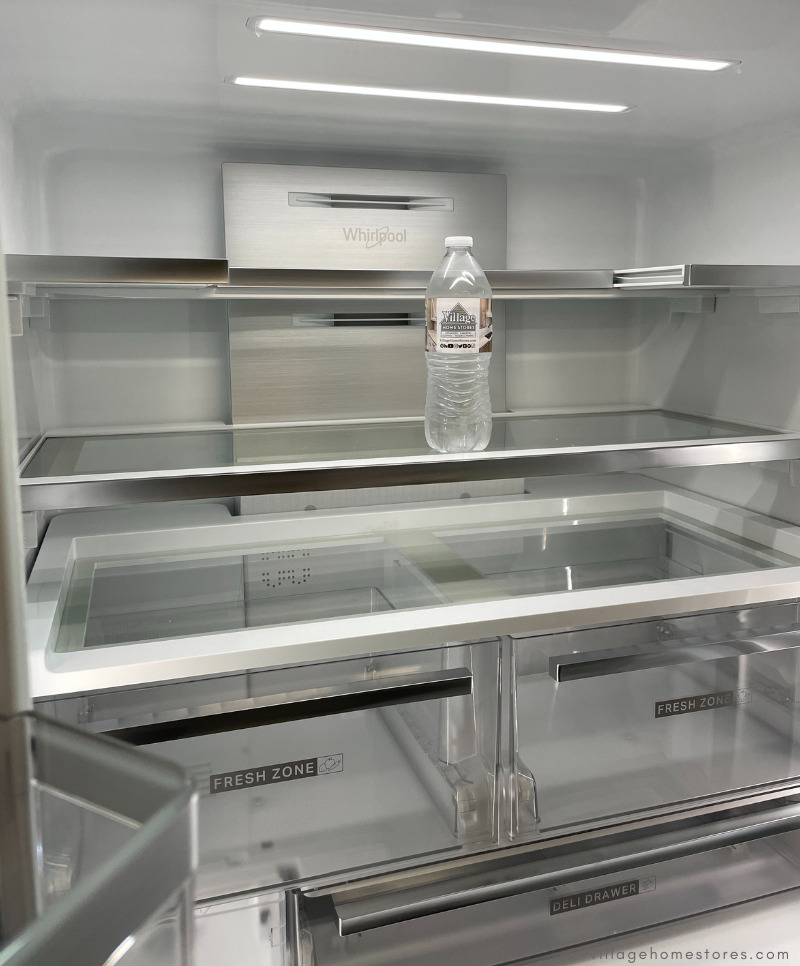 interior of whirlpool refrigerator with tuck away shelf for tall items