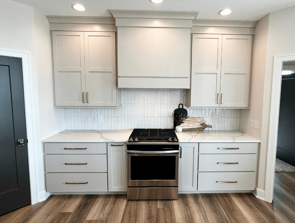 accessible beige kitchen cabinets in a quad cities home. Kitchen by Village Home Stores for aspen homes