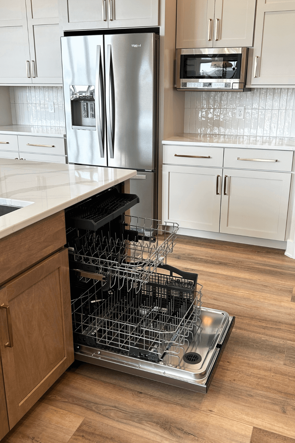whirlpool appliances in Bettendorf kitchen showing three level dishwasher with door open installed in island