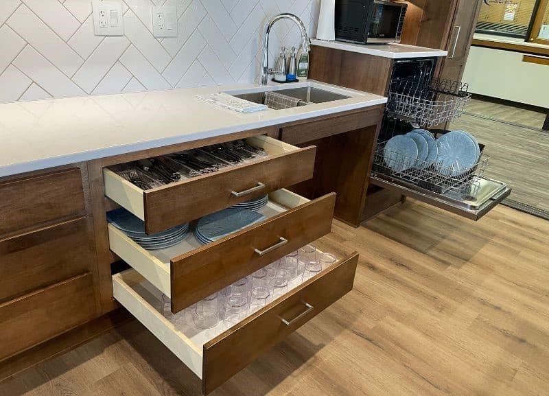 ada roll up sinkbase setup with raised dishwasher and drawer storage