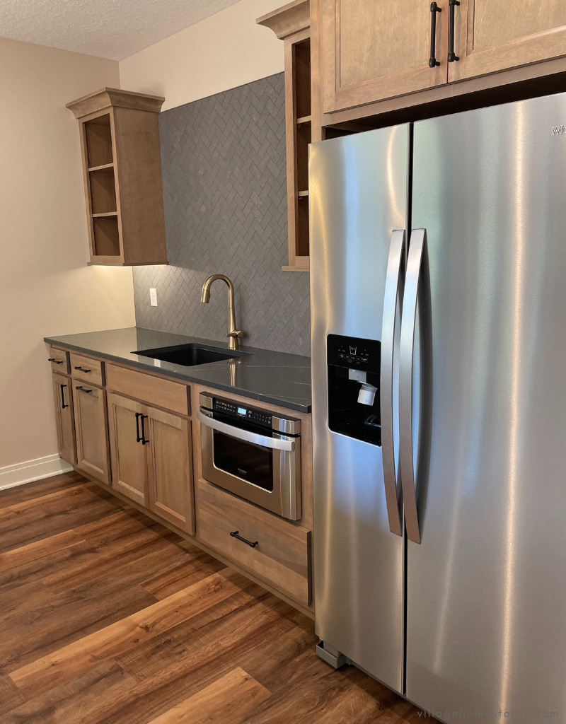 lower level bar design with bar sink and appliances
