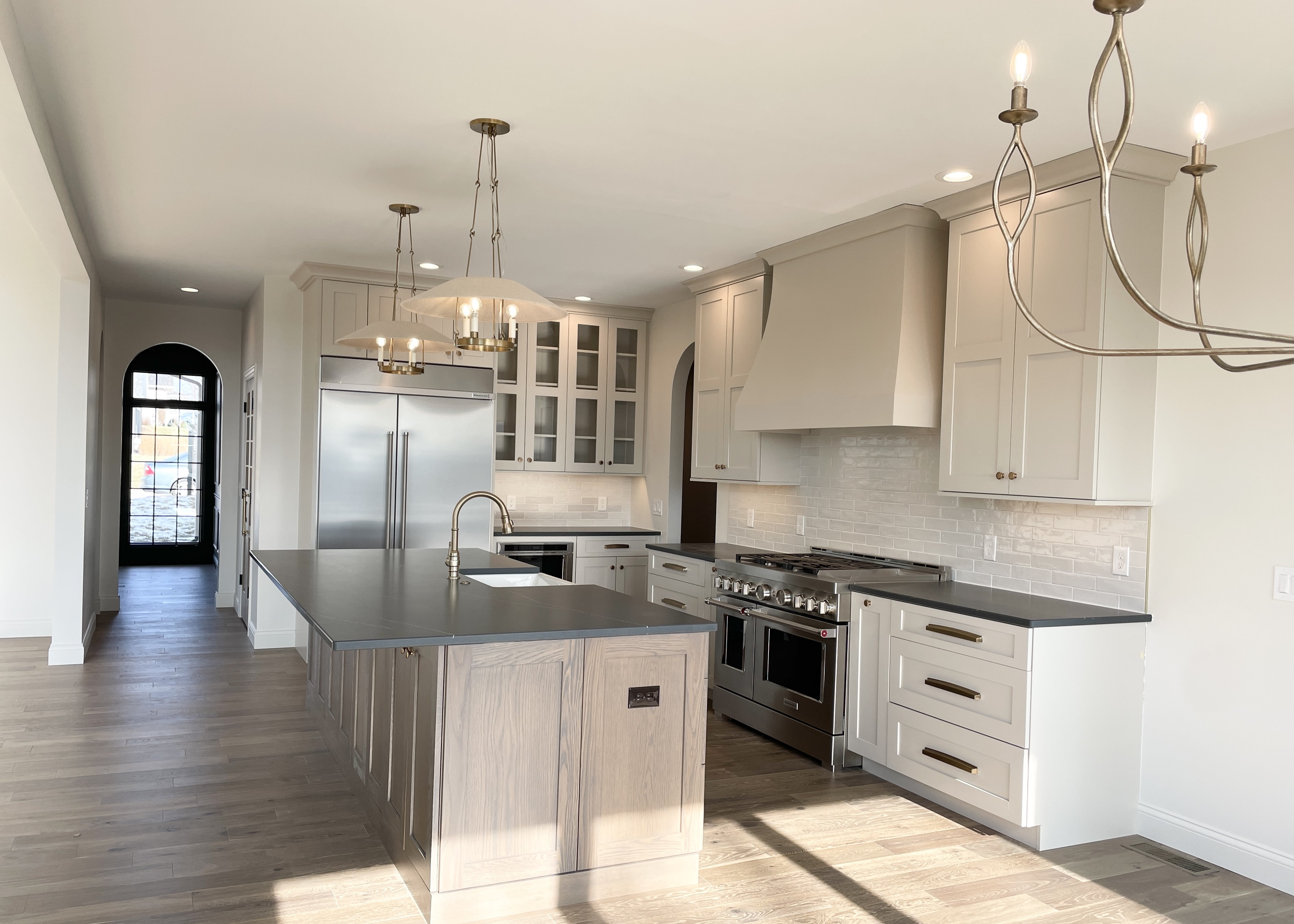 kitchen design in quad cities with painted cabinets and brass lighting
